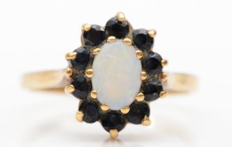 A 9ct gold opal and sapphire cluster ring, O, 2.4gm.