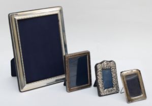 A silver photograph frame, Sheffield 1996, 21 x 16cm and three smaller examples of a similar age