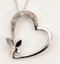 A 9ct white gold heart and butterfly diamond pendant, on chain, 18 x 17mm, 1.4gm.