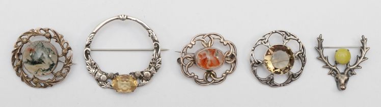 A group of five Scottish silver brooches to include a Robert Allison citrine and thistle brooch,