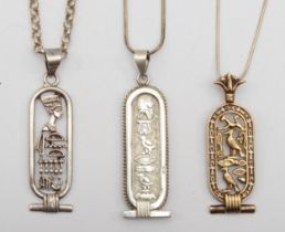 Three silver Egyptian pendents on chains, largest 53mm, 42gm.