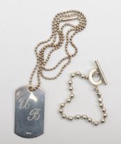 Gucci, a silver dog tag pendant on a beaded chain 49 x 27mm, together with a t-bar bracelet, 45gm.