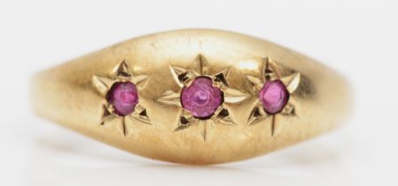 A 9ct gold three stone ruby dress ring, N, 1.7gm.