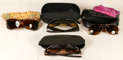 Four pairs of Oakley sunglasses.