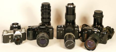 Four 35mm film cameras with lenses to include a Zenit ET with a Soligor 200mm f4.5 lens, a Nikon