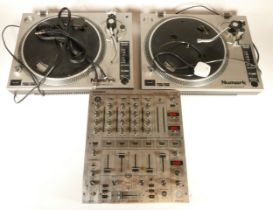 A pair of Numark turntables, TT-1520, together with a Behringer DJ mixer deck, model DJX 700.