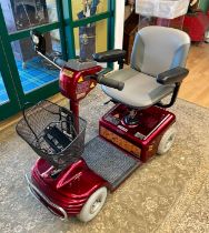 A Shoprider four wheeled mobility scooter, complete with charger in working order.