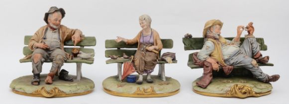 Three 20th century painted porcelain Capodimonte figures, Tramp feeding a squirrel together with a