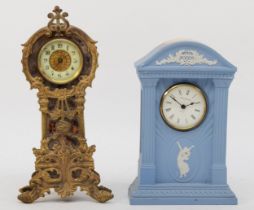 A 20th century blue and white Wedgewood Jasperware cased quartz mantle clock, 20cm high together