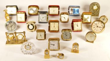 A collection of mid 20th century and later mantel clocks and traveling alarm clocks, having manual