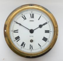 An early 20th century brass cased Sestrel bulkhead clock, 19.5cm diameter.