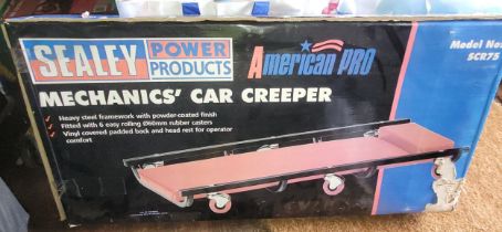 A boxed Sealey Mechanic's car creeper, and foam pad.