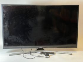A Samsung TV 40 inch, model VE40 MU6120K, with power lead and remote control.