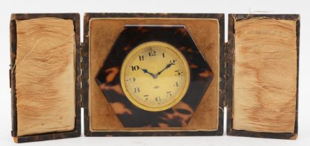 A 1930s Art Deco Swiss 8 day hexagonal tortoiseshell cased easel clock, in original fitted case, 9.