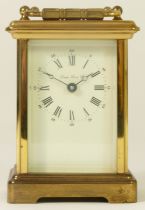 London Clock Co., a brass carriage time piece with white enamel dial, key, 12cm high