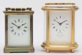 A 20th century Garrard oval brass cased carriage clock, 17cm high together with a 20th century brass