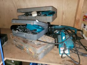 A group of Makita power tools to include a 800mm chain saw, UC3001A, two hand drills, 04198,