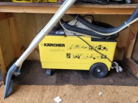 A Karcher puzzi-s carpet cleaner.