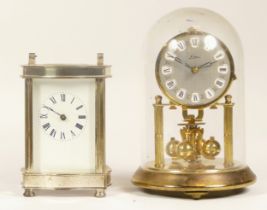 A 20th century German brass anniversary clock, 17cm high together with a chrome plated carriage