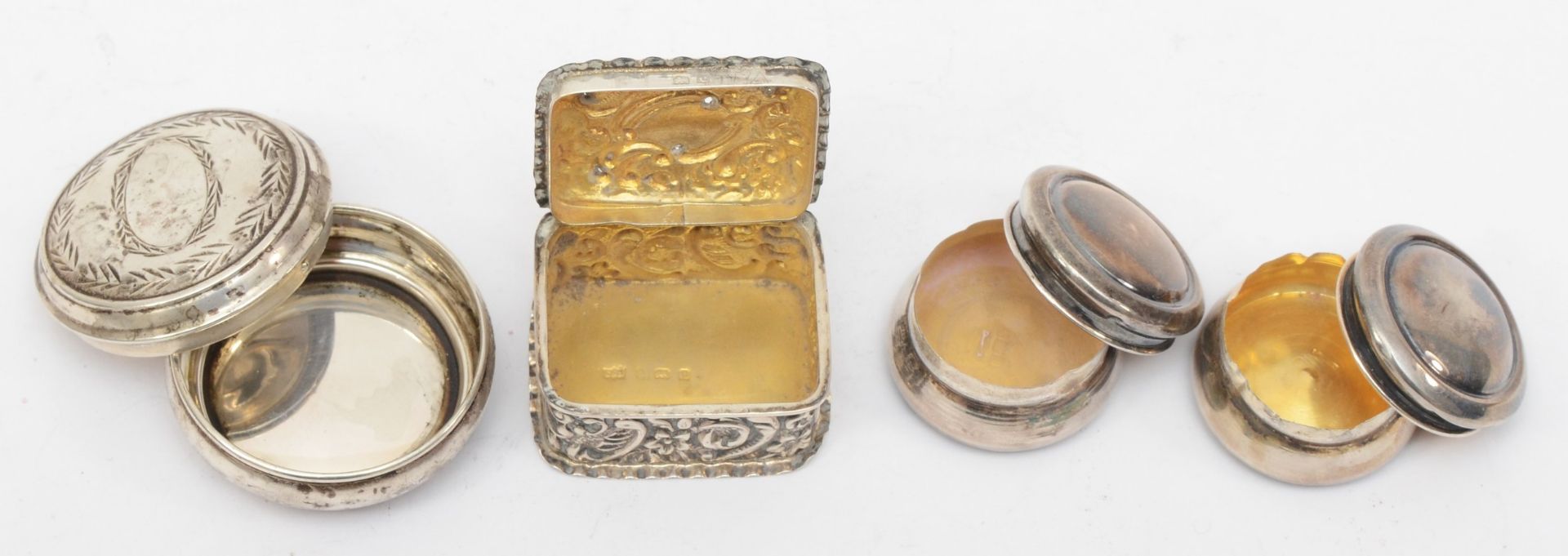 Four silver pill boxes to include a Victorian embossed foliate scroll example, London 1898, 4 x 3. - Image 3 of 3