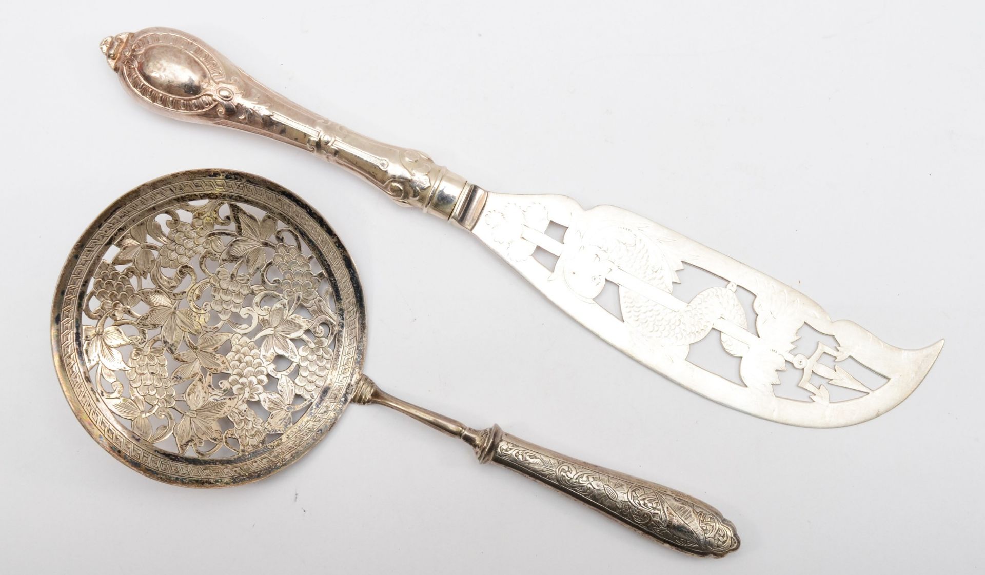 An early 20th century Iranian silver server, with pierced floral decoration, stamped control