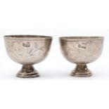 Two Ottoman Empire silver cups with chased scrolling decoration, 4.5 x 5.5cm, 52gm.