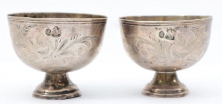 Two Ottoman Empire silver cups with chased scrolling decoration, 4.5 x 5.5cm, 52gm.