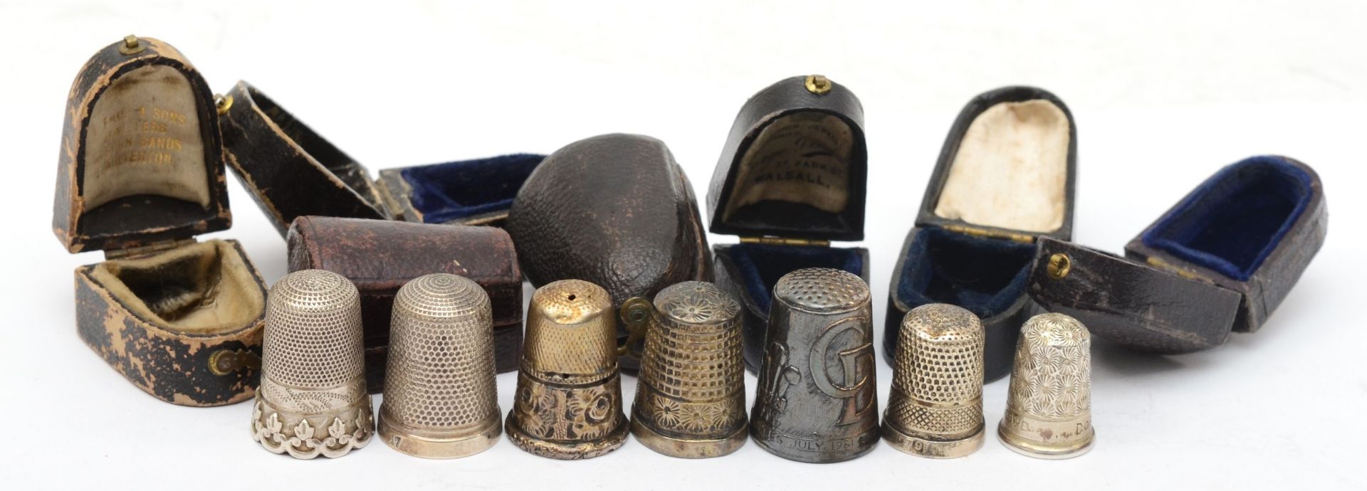 Seven leather cased silver thimbles to include a Charles Horner example, Chester 1905 (possibly),