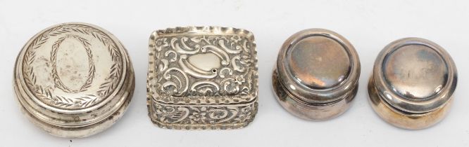 Four silver pill boxes to include a Victorian embossed foliate scroll example, London 1898, 4 x 3.