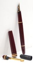 Mont Blanc Meisterstuck, a burgundy cartridge fountain pen, with 14K gold nib, cap holder broken,