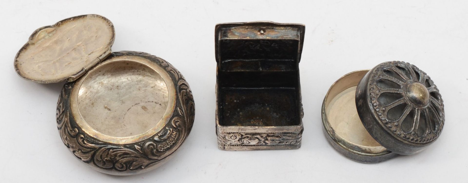 A Dutch silver pill box with embossed foliate scroll and windmill decoration, 4cm, together with two - Image 2 of 2