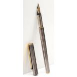 Mont Blanc, a polished stainless steel cartridge fountain pen with 585 gold nib.