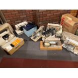 Five assorted cased sewing machines to include New Home, Singer and Regency (5)