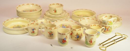 Royal Doulton Bunnykins; to include three cake stands, cups, bowls and children's feeding bowls.