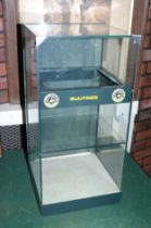 A black metal and glass table top display case with Bultaco stickers, 70 x 35 cm.