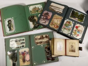 A collection of over two hundred early 20th century and later postcards in three albums, together