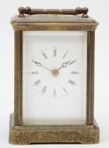 A 20th century engraved brass cased hourly striking carriage clock, the white enamelled dial with