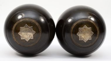 A pair of Victorian Scottish Lignum Vitae trophy lawn bowls, with silver star insets inscribed