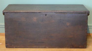 A 19th/early 20th century stained pine tapering twin handled travelling trunk, the hinged lid