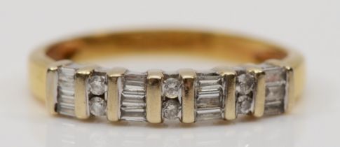 An 18ct gold brilliant cut and baguette cut diamond ring, N, 2.3gm