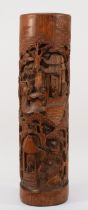 A 20th century Chinese carved bitong (bushpot), with deeply relief carved village scene, 38cm high.