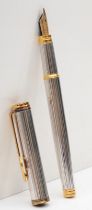 Watermans, a silver and gold plated limited edition plunger filling fountain pen, with 18K gold nib,