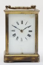A 20th century brass corniche cased hourly striking carriage clock, the white dial with black