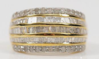 A 9ct gold diamond dress ring, three channel set rows of baguette cut diamonds flanked by two rows