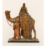 A cold painted spelter table lighter of two Arab gentlemen selling carpets on the back of a camel,