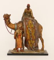 A cold painted spelter table lighter of two Arab gentlemen selling carpets on the back of a camel,