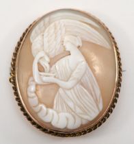 A gold shell carved cameo brooch, c.1900, depicting Hebe goddess of youth feeding Zeus in the