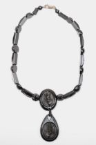 A Victorian Whitby jet and silver clasped necklace, with carved floral pendant and spacers, 44cm, re