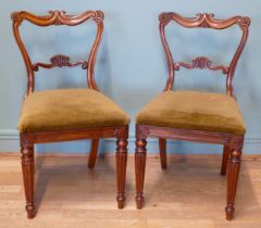 A pair of George IV carved rosewood dining chairs, circa 1825 in the manner of Gillows, having later