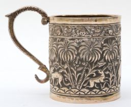 An Indian silver small mug, embossed and chased with animals amongst palm trees, snake handle, 7.